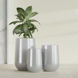 Hayden Urn fiberglass planter in Metallic Silver, size range, in a sunlit interior