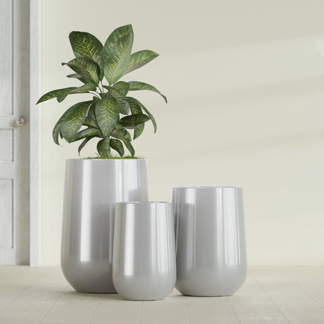 Hayden Urn fiberglass planter in Metallic Silver, size range, in a sunlit interior