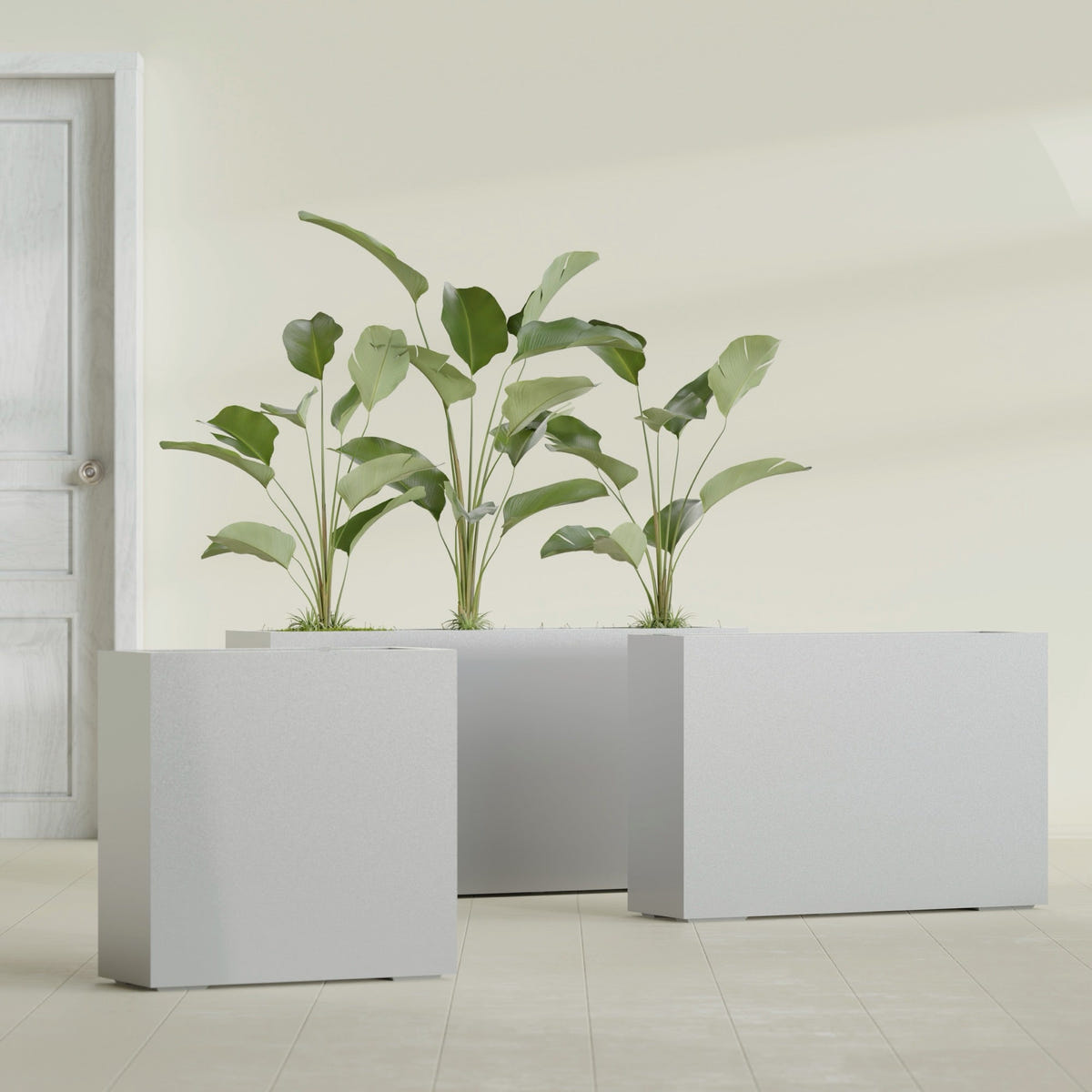 Milano Narrow Rectangular fiberglass planter in Metallic Silver, shown planted, in a sunlit interior