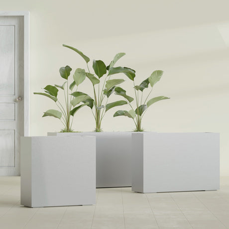 Milano Narrow Rectangular fiberglass planter in Metallic Silver, shown planted, in a sunlit interior