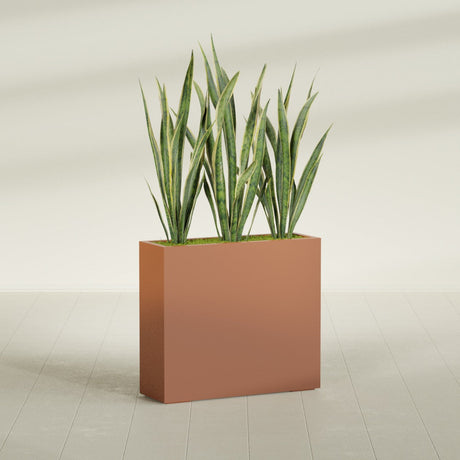 Delray Rectangular fiberglass planter in Matte Terra Cotta, shown planted, in a sunlit interior