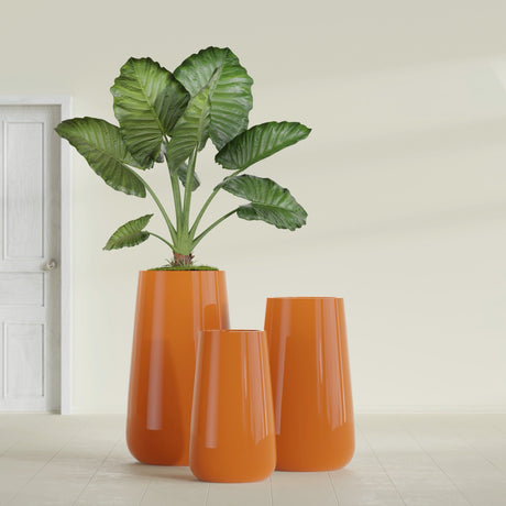 Saigon Tapered Round fiberglass planter in Gloss Tangerine, size range, in a sunlit interior
