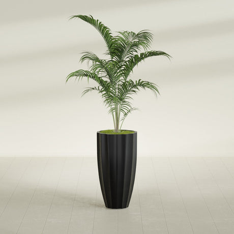 San Jose Tall Fluted fiberglass planter in Matte Black, shown planted, in a sunlit interior