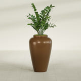 Barà Jar fiberglass planter in Metallic Bronze, shown planted, in a sunlit interior