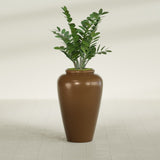 Barà Jar fiberglass planter in Metallic Bronze, shown planted, in a sunlit interior