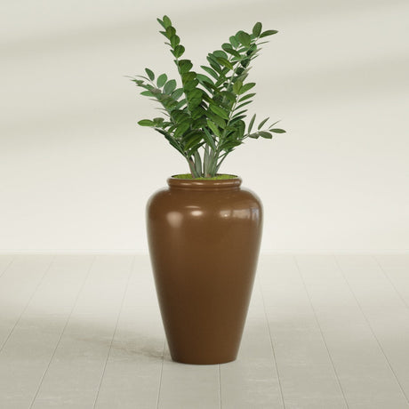 Barà Jar fiberglass planter in Metallic Bronze, shown planted, in a sunlit interior