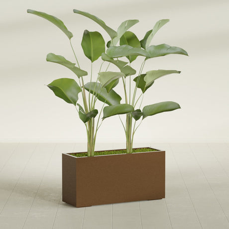 Tolga Corner fiberglass planter in Metallic Bronze, shown planted, in a sunlit interior