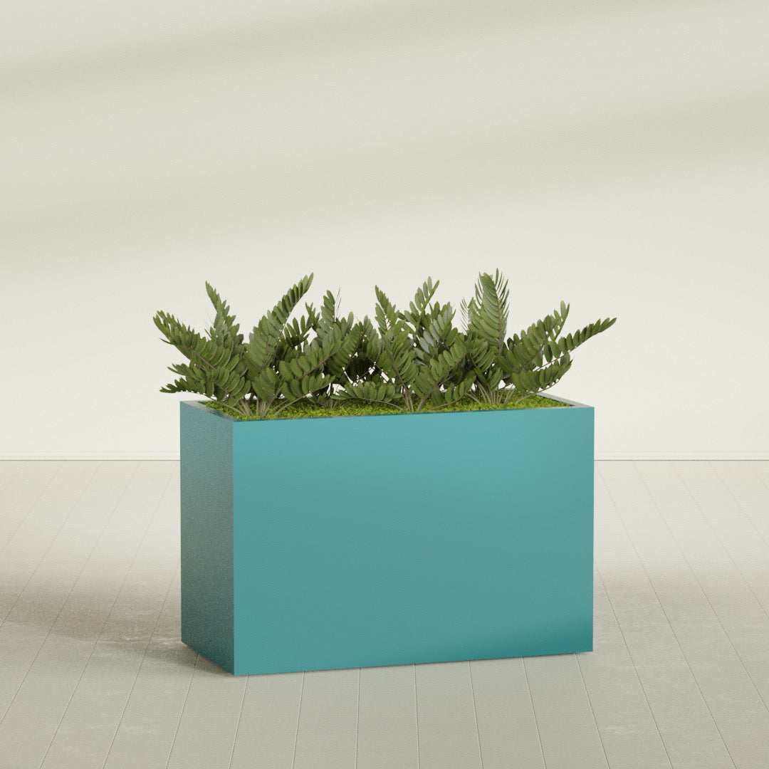 Brisbane Rectangular fiberglass planter in Satin Seafoam Green, shown planted, in a sunlit interior