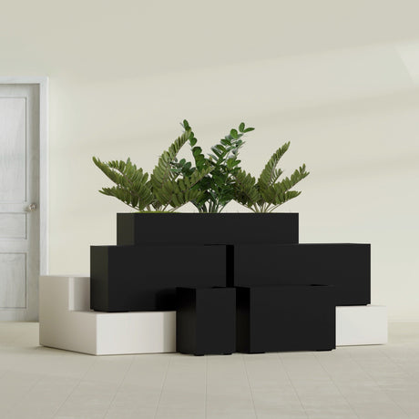 Tolga Corner fiberglass planter in Matte Black, size range, in a sunlit interior