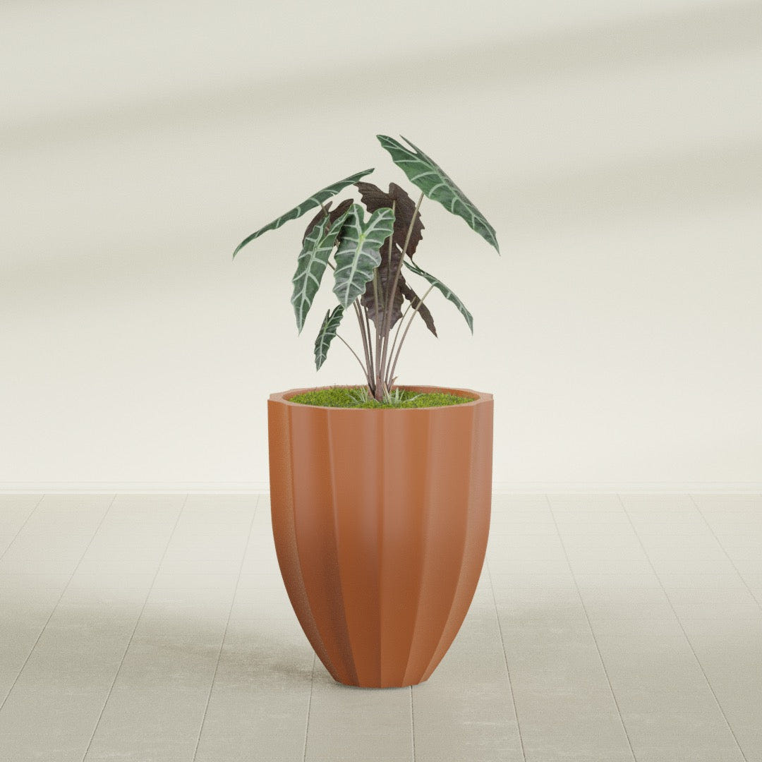 Alicante Fluted fiberglass planter in Matte Terra Cotta, shown planted, in a sunlit interior