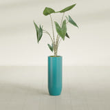 Saint Tropez Bullet Round fiberglass planter in Satin Seafoam Green, shown planted, in a sunlit interior