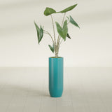 Saint Tropez Bullet Round fiberglass planter in Satin Seafoam Green, shown planted, in a sunlit interior