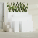 Delray Corner fiberglass planter in Matte Bright White, size range, in a sunlit interior