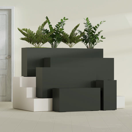 Hollywood Corner fiberglass planter in Matte Charcoal, size range, in a sunlit interior