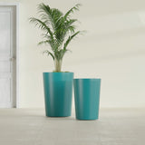 Tegel Round Tapered fiberglass planter in Satin Seafoam Green, size range, in a sunlit interior