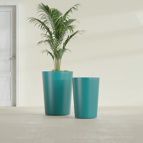 Tegel Round Tapered fiberglass planter in Satin Seafoam Green, size range, in a sunlit interior