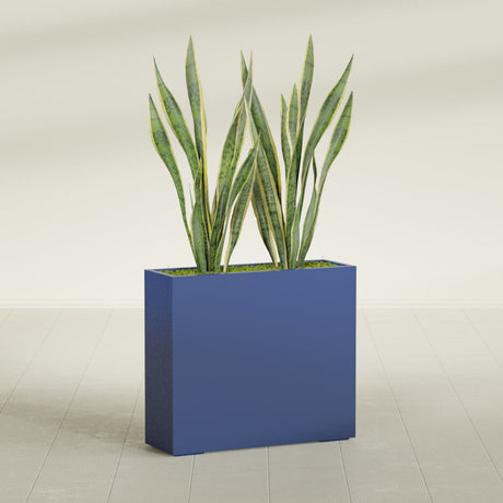 Perth Corner fiberglass planter in Matte Cobalt Blue, shown planted, in a sunlit interior