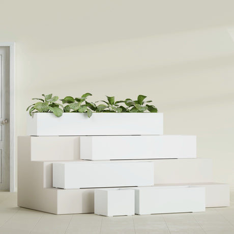 Cuba Corner fiberglass planter in Gloss Bright White, size range, in a sunlit interior