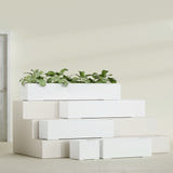 Cuba Low Rectangular fiberglass planter in Gloss Bright White, size range, in a sunlit interior