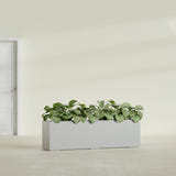 Hudson Extra Long fiberglass planter in Metallic Silver, shown planted, in a sunlit interior