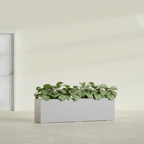 Hudson Extra Long fiberglass planter in Metallic Silver, shown planted, in a sunlit interior