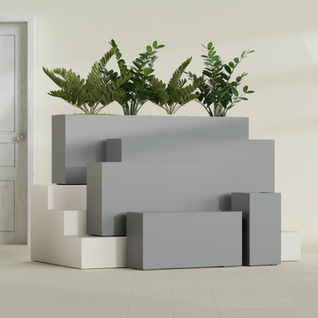 Hollywood Corner fiberglass planter in Matte Gunmetal, size range, in a sunlit interior