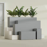 Hollywood Narrow Rectangular fiberglass planter in Matte Gunmetal, size range, in a sunlit interior
