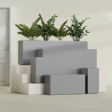 Hollywood Narrow Rectangular fiberglass planter in Matte Gunmetal, size range, in a sunlit interior