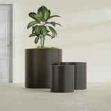 Rio Grande Cylinder fiberglass planter in Matte Dark Brown, size range, in a sunlit interior