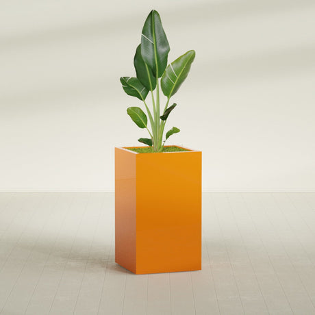 Darwin Rectangular fiberglass planter in Gloss Tangerine, shown planted, in a sunlit interior