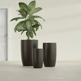 Lisbon Tall Round fiberglass planter in Matte Dark Brown, size range, in a sunlit interior