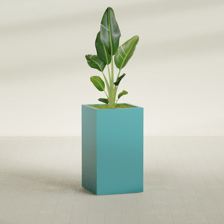 Darwin Corner fiberglass planter in Satin Sea Foam, planted, in a sunlit interior