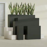 Delray Corner fiberglass planter in Matte Charcoal, size range, in a sunlit interior