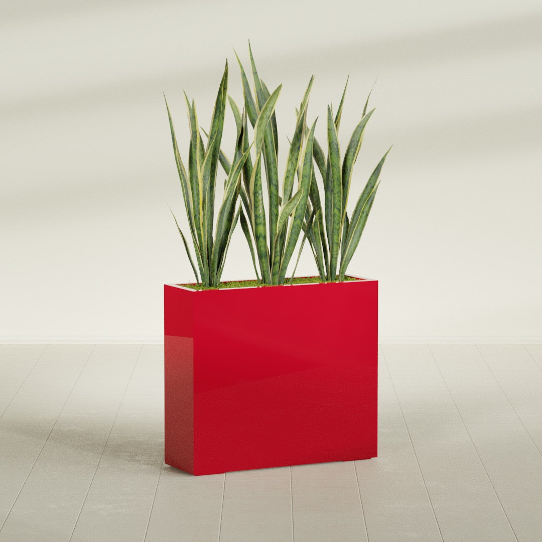 Delray Corner fiberglass planter in Gloss Red, shown planted, in a sunlit interior