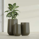 Hayden Urn fiberglass planter in Matte Bronze, size range, in a sunlit interior