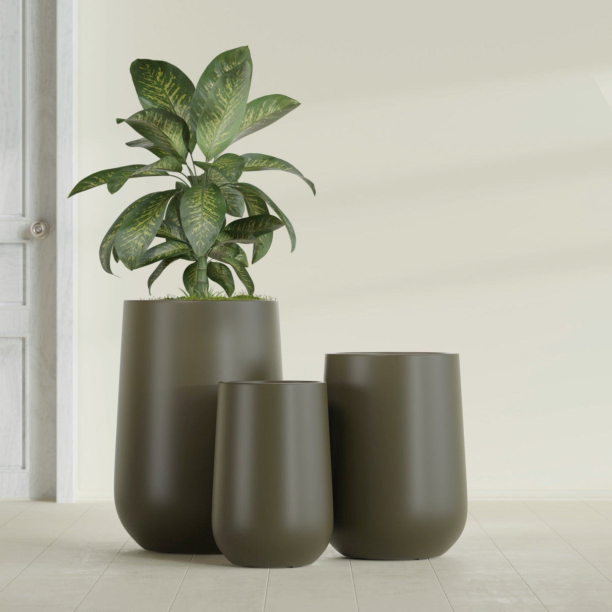 Hayden Urn fiberglass planter in Matte Bronze, size range, in a sunlit interior
