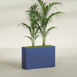 Potsdam Corner fiberglass planter in Matte Cobalt Blue, shown planted, in a sunlit interior