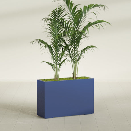 Potsdam Corner fiberglass planter in Matte Cobalt Blue, shown planted, in a sunlit interior