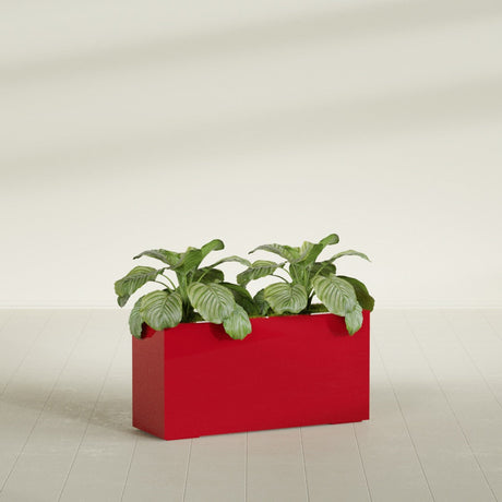 Miami Corner fiberglass planter in Gloss Red, shown planted, in a sunlit interior