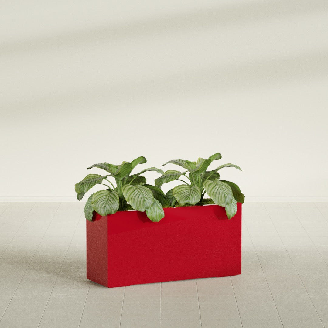 Miami Narrow Rectangular fiberglass planter in Gloss Red, shown planted, in a sunlit interior
