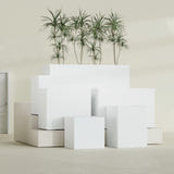 Brisbane Corner fiberglass planter in Matte Bright White, size range, in a sunlit interior