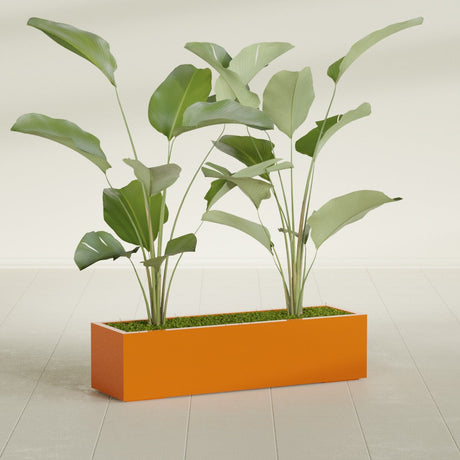 Cuba Corner fiberglass planter in Gloss Tangerine, shown planted, in a sunlit interior
