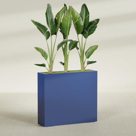 Amesbury Narrow Rectangular fiberglass planter in Matte Cobalt Blue, shown planted, in a sunlit interior