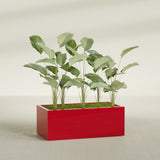 Torino Wide Rectangular fiberglass planter in Gloss Red, shown planted, in a sunlit interior