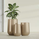 Hayden Urn fiberglass planter in Gloss Metallic Gold, size range, in a sunlit interior