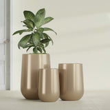 Hayden Urn fiberglass planter in Gloss Metallic Gold, size range, in a sunlit interior