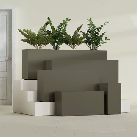 Hollywood Corner fiberglass planter in Matte Bronze, size range, in a sunlit interior