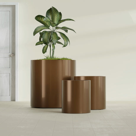 Rio Grande Cylinder fiberglass planter in Metallic Bronze, size range, in a sunlit interior