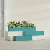 Monaco Rectangle fiberglass planter in Satin Seafoam Green, shown planted, in a sunlit interior