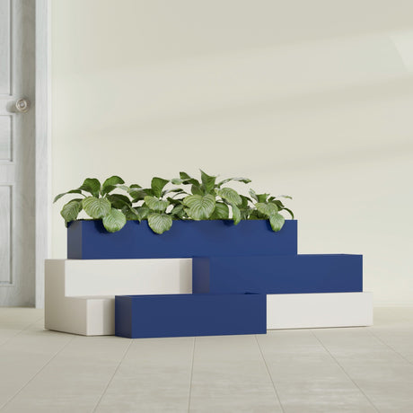 Monaco Rectangle fiberglass planter in Matte Cobalt Blue, shown planted, in a sunlit interior